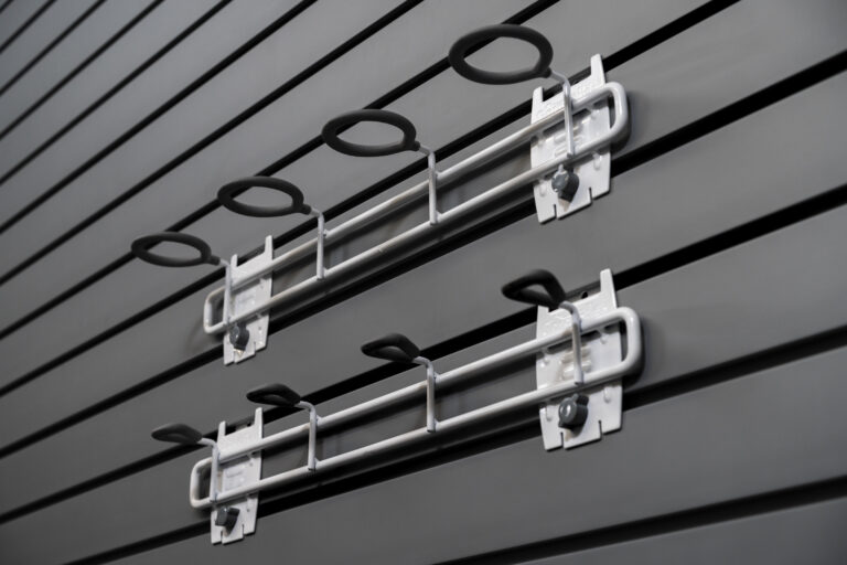 Cue and fishing hook holder on slatwall