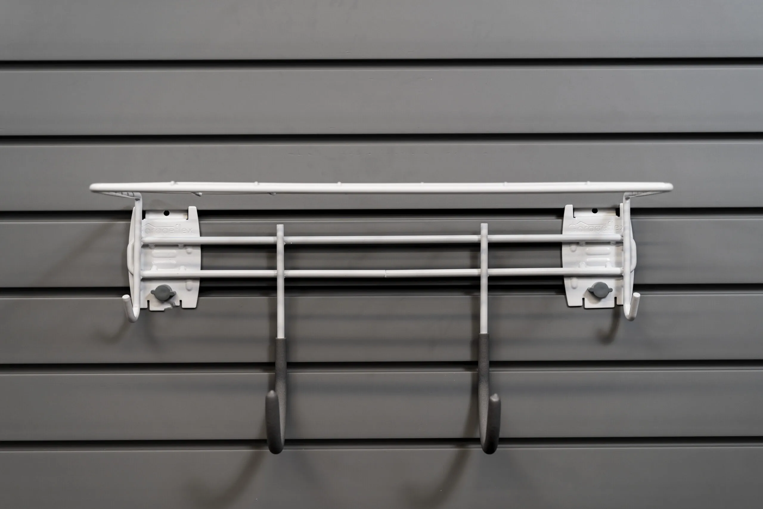 shelf with 2 hooks attached to slatwall